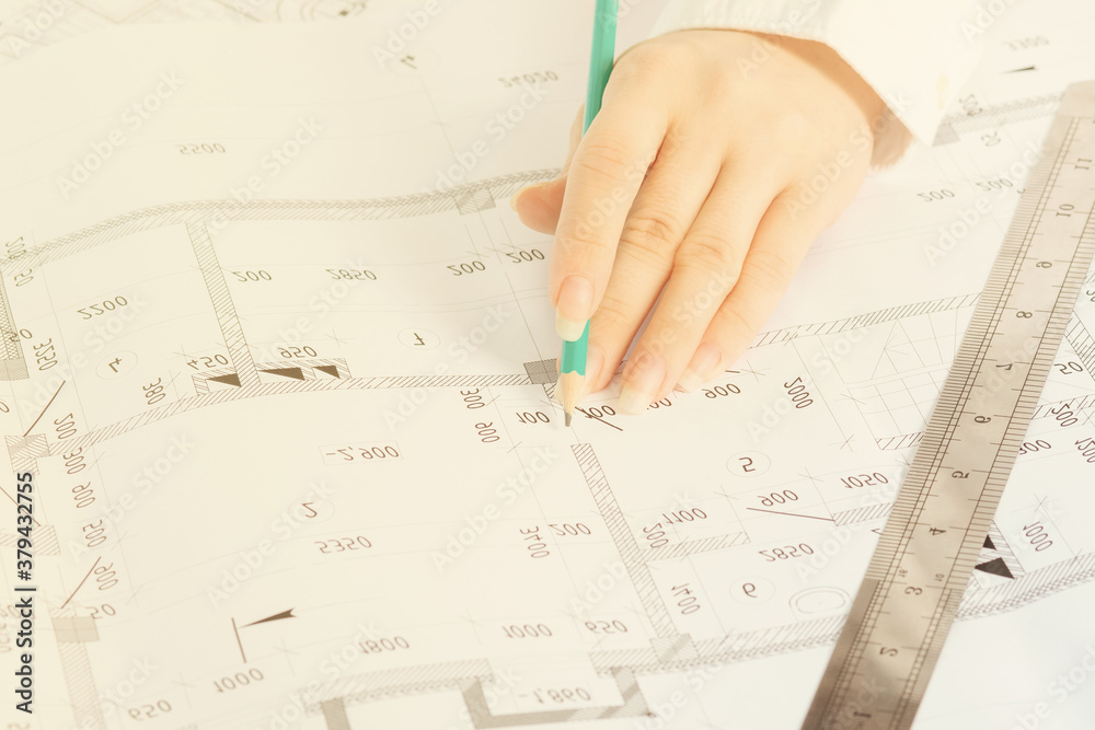 Architecture and construction. The architect works in an office, making a sketch of the interior design Architecture and construction. The architect works in an office, making a sketch of the interior design