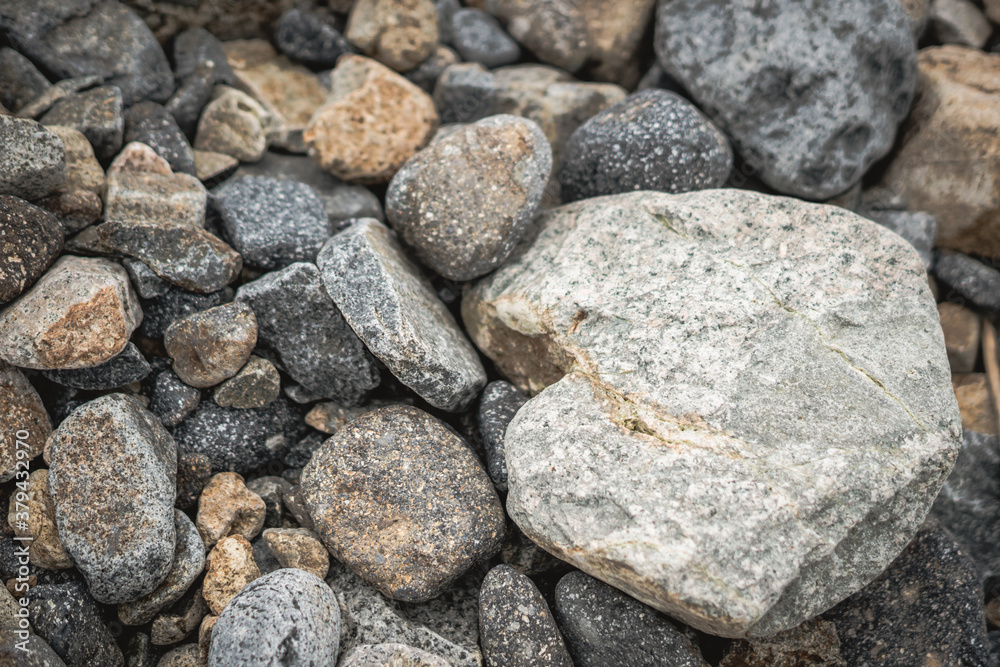 Small and big smooth round pebbles, sea dry stones, multicolour gray gravel. Abstract Composition Textured background. Ideal for web banner design Small and big smooth round pebbles, sea dry stones, multicolour gray gravel. Abstract Composition Textured background. Ideal for web banner design