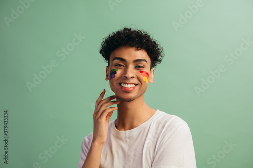 Man with face paint celebrates gay pride