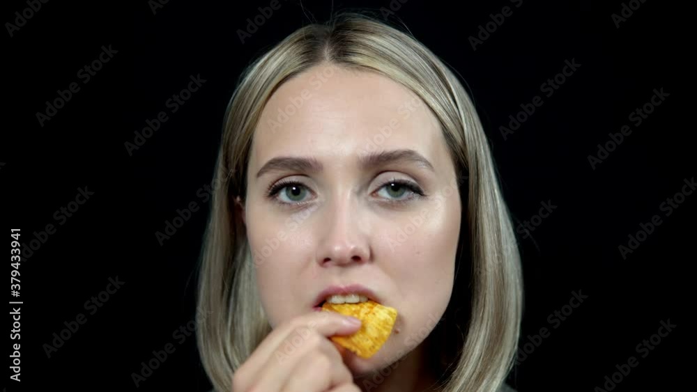 Woman holding a bowl of chips in her hands and eating Woman holding a bowl of chips in her hands and eating