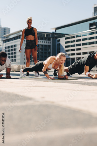 Fototapeta Naklejka Na Ścianę i Meble -  People exercising outdoors in the city