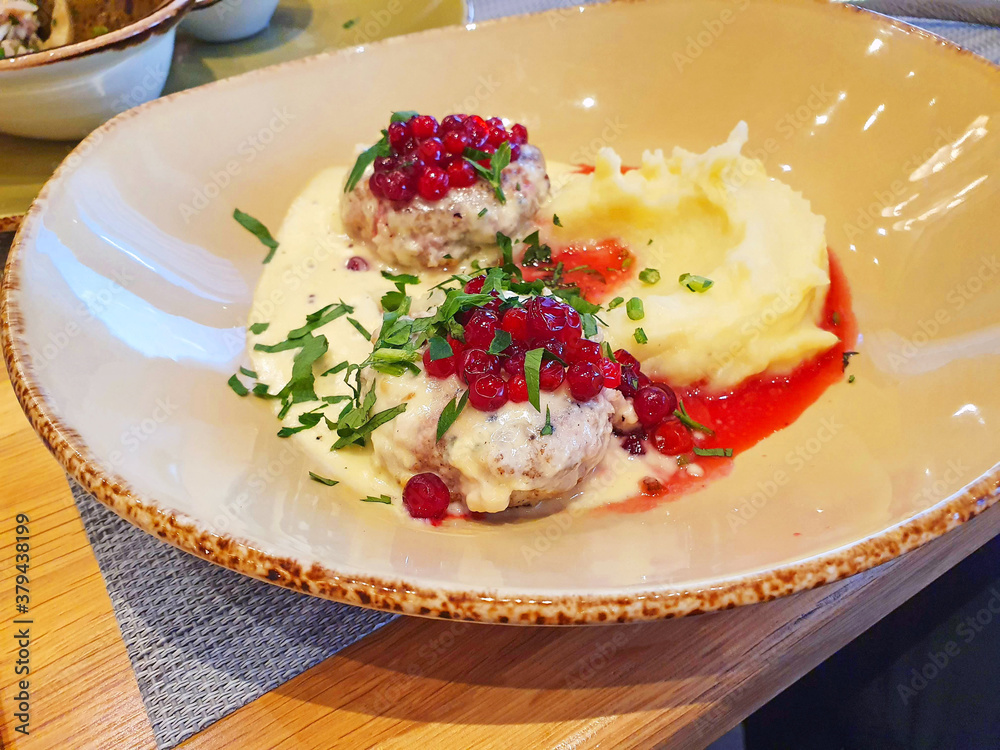 poultry cutlets with mashed potatoes and lingonberry-berry sauce, sprinkled with herbs poultry cutlets with mashed potatoes and lingonberry-berry sauce, sprinkled with herbs