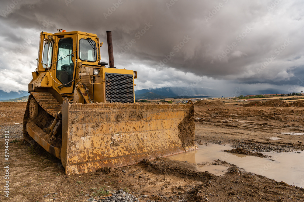 Excavator working on a muddy construction site