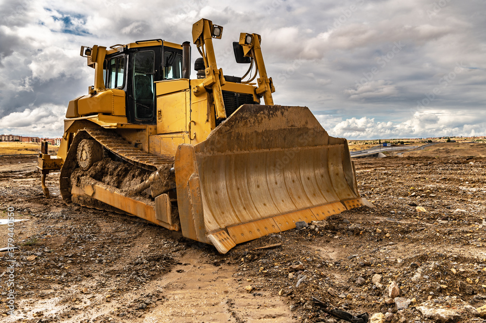 Excavator working on a muddy construction site Excavator working on a muddy construction site