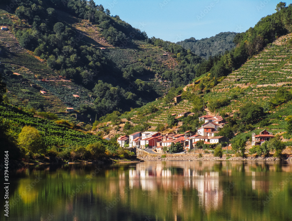 reflection in the water of a town on the slopes