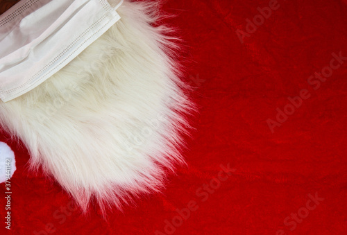 Christmas Santa Claus white furry beard on red fabric, Christmas concept, background texture