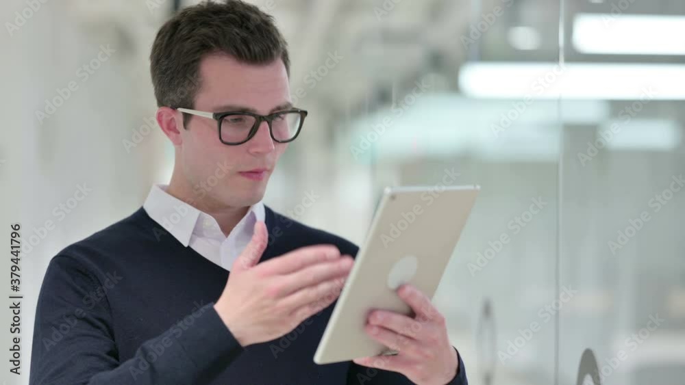 Young Businessman doing Video Call on Digital Tablet Young Businessman doing Video Call on Digital Tablet