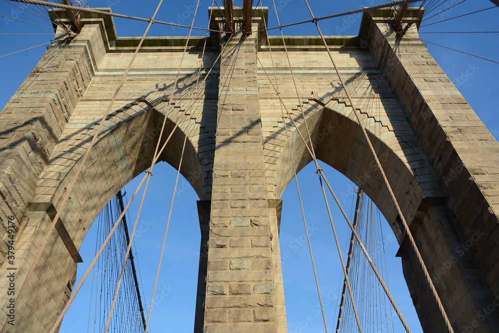 Fototapeta premium New York, NY, USA - June 3, 2019: Brooklyn Bridge connects Manhattan and Brooklyn
