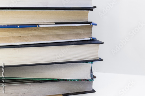 a stack of hardcover books on a white background. Concept of knowledge and learning