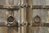 Closeup of Old Rustic Wooden Door with Metal Ring Handles