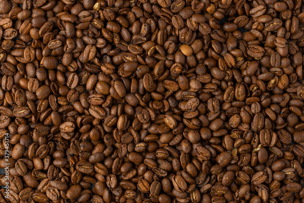 Close-up studio shot of freshly roasted espresso coffee beans.