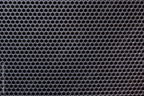 Black metal grate with small holes.