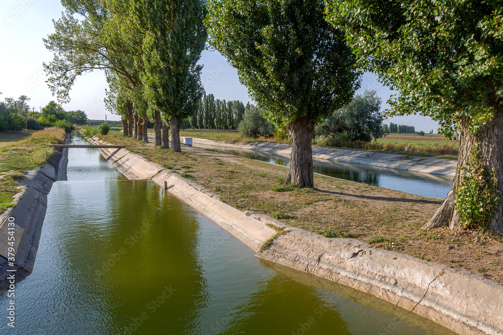 Agricultural canal or irrigation canal in a concrete wall Direct water to the farmer's farmland in arid areas of risky farming Agricultural canal or irrigation canal in a concrete wall Direct water to the farmer's farmland in arid areas of risky farming