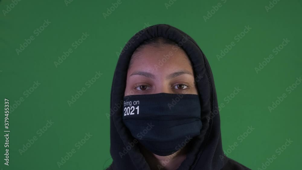 Female Teenager Wearing Hoodie And Bring It On 2021 Face Mask. Green Screen, Locked Off Female Teenager Wearing Hoodie And Bring It On 2021 Face Mask. Green Screen, Locked Off
