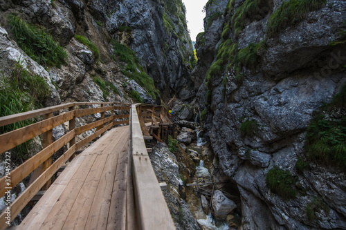 wooden bridge with waterfalls in a gorge