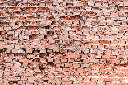 Old crumbled brick wall texture background.