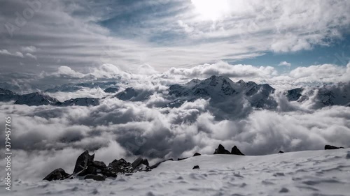 Timelapse winter scenery with moving clouds and blue sky. Glacier and mountains in South Tyrol. photo