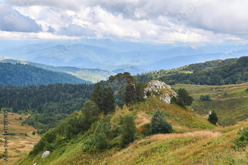 Wallpaper Mural beautiful mountain landscape with wooded rocky hill in the foreground and blue peaks in the distance Torontodigital.ca