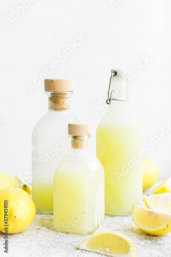 Italian traditional liqueur limoncello with lemons