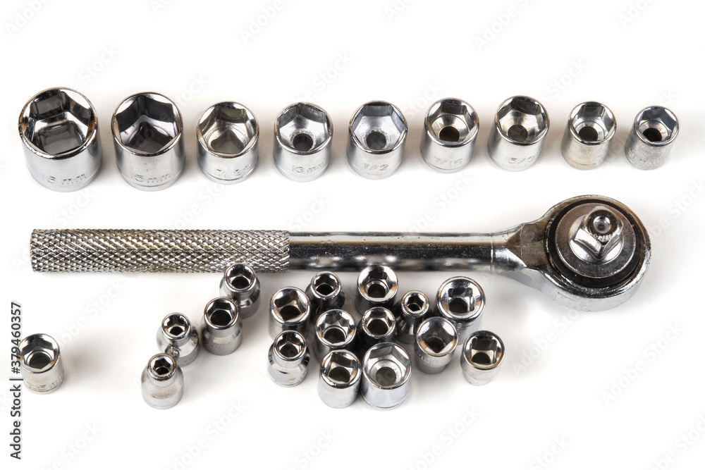 Socket spanner wrench and various wrench heads closeup on a white background Socket spanner wrench and various wrench heads closeup on a white background
