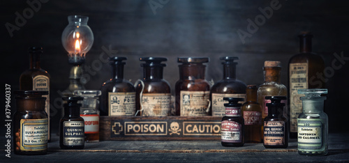 Bottles with drugs from old medical  chemical and pharmaceutical glass. Chemistry and pharmacy history concept background. Retro style. Chemical substances.