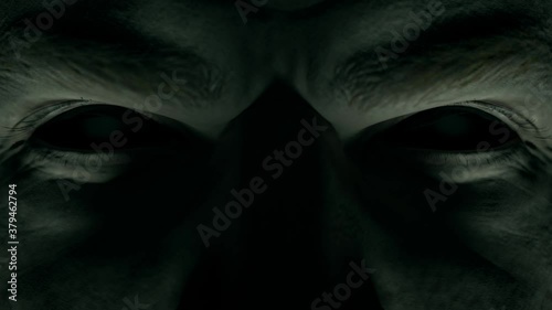 Scary menacing gaze of a man with empty black eyes close-up photo