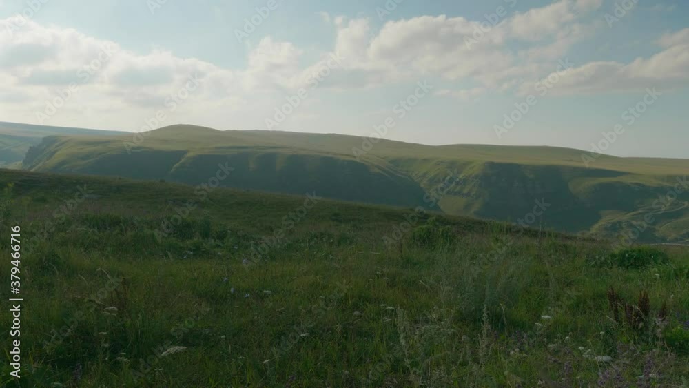 View of green plateau Bermamyth in the afternoon. Sunny summer day in Russia. Clouds are above View of green plateau Bermamyth in the afternoon. Sunny summer day in Russia. Clouds are above