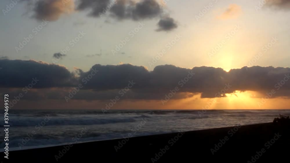 Time lapse sunset of golden clouds on Samas beach, Yogyakarta, Indonesia. Perfect for beach theme, travel, wonderful, fisherman, angler, etc Time lapse sunset of golden clouds on Samas beach, Yogyakarta, Indonesia. Perfect for beach theme, travel, wonderful, fisherman, angler, etc