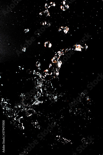 Splash of clear water on black isolated background.