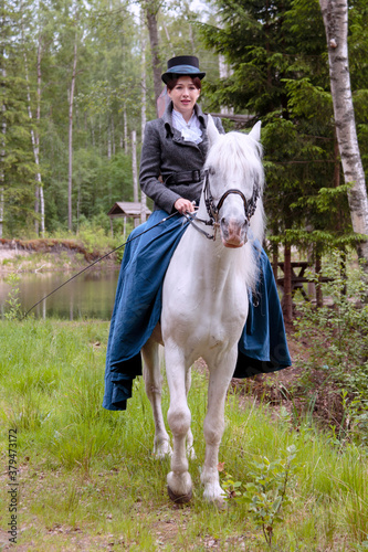Young girl on a horse. Walking in the woods