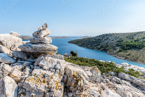 Stone pyramid on top of the mountain of the island of Lavsa of the Kornati archipelago in the Adriatic sea photo