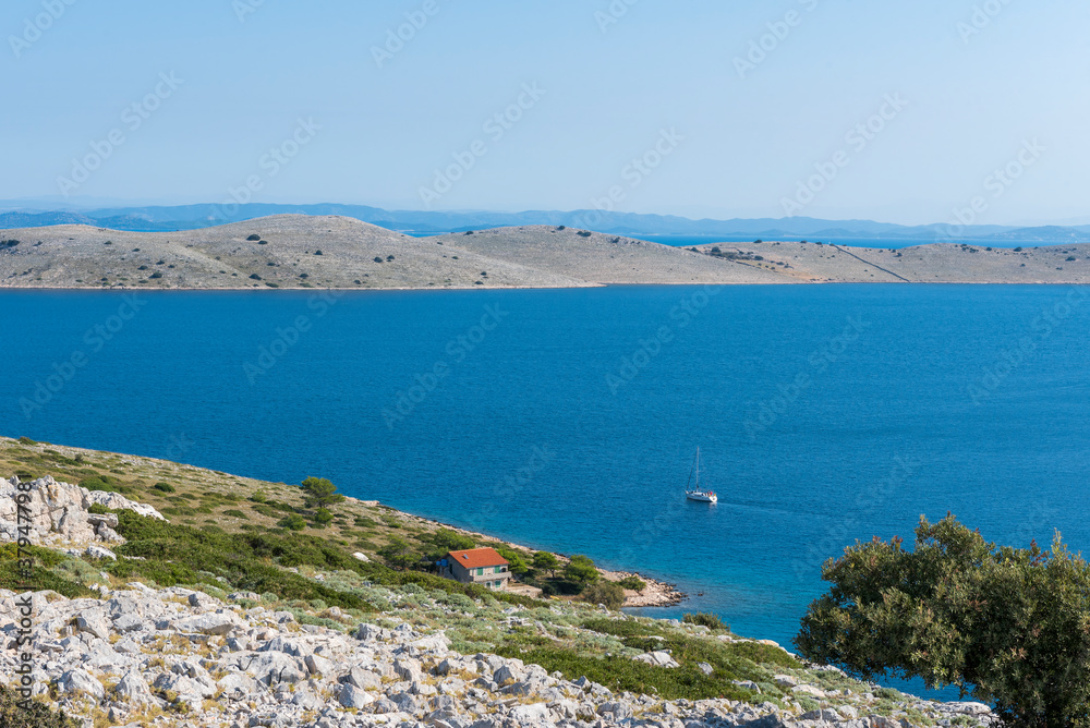 Top view of the Adriatic sea, the rocky Islands of the Kornati archipelago, Croatia, and the yacht, sailing from island