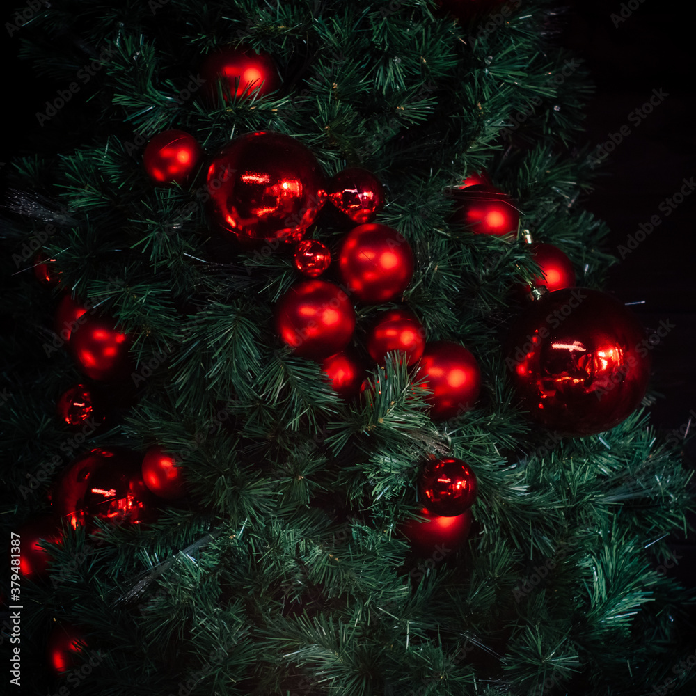 Red Christmas balls on Christmas green tree