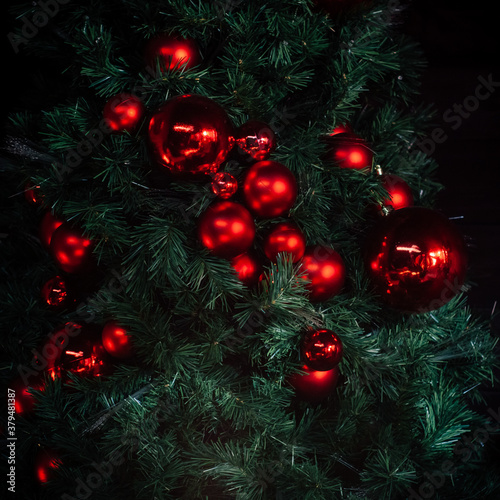 Red Christmas balls on Christmas green tree
