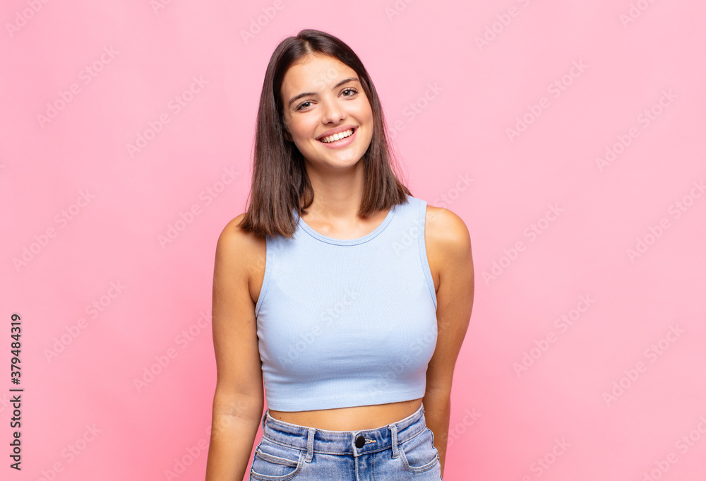 Fototapeta premium young pretty woman looking proud, confident, cool, cheeky and arrogant, smiling, feeling successful