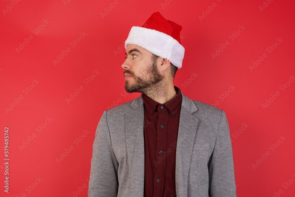 Close up side profile photo Young caucasian businessman wearing casual clothes standing over isolated red background ready to have a walk. Close up side profile photo Young caucasian businessman wearing casual clothes standing over isolated red background ready to have a walk.