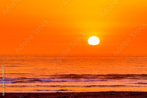 Orange sunset over Ocean with Sun