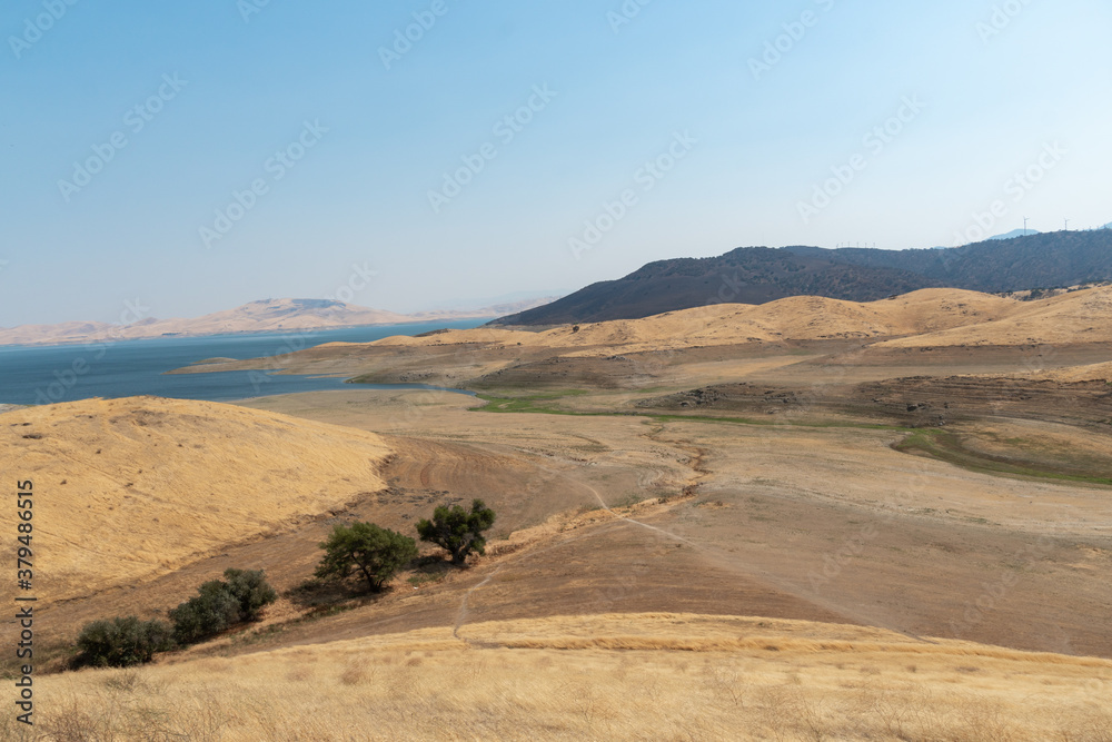 The San Luis Reservoir during dry and hot season, artificial lake on San Luis Creek in the eastern slopes of the Diablo Range of Merced County, California. USA