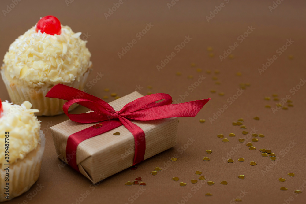 Gift boxes and vanilla cupcakes with cherry on top. Birthday concept. Sweet dessert with copy space. Gift boxes and vanilla cupcakes with cherry on top. Birthday concept. Sweet dessert with copy space.