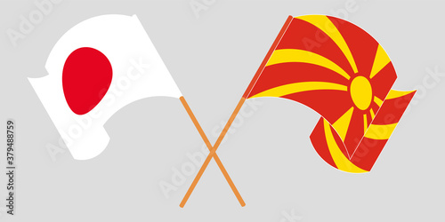 Crossed and waving flags of North Macedonia and Japan