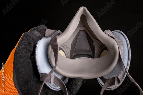 Dust mask in hand. Respiratory protection accessories.
