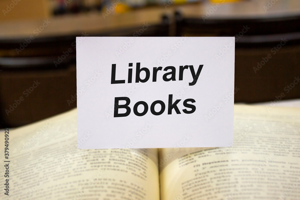 Library books written in white note on open books Library books written in white note on open books