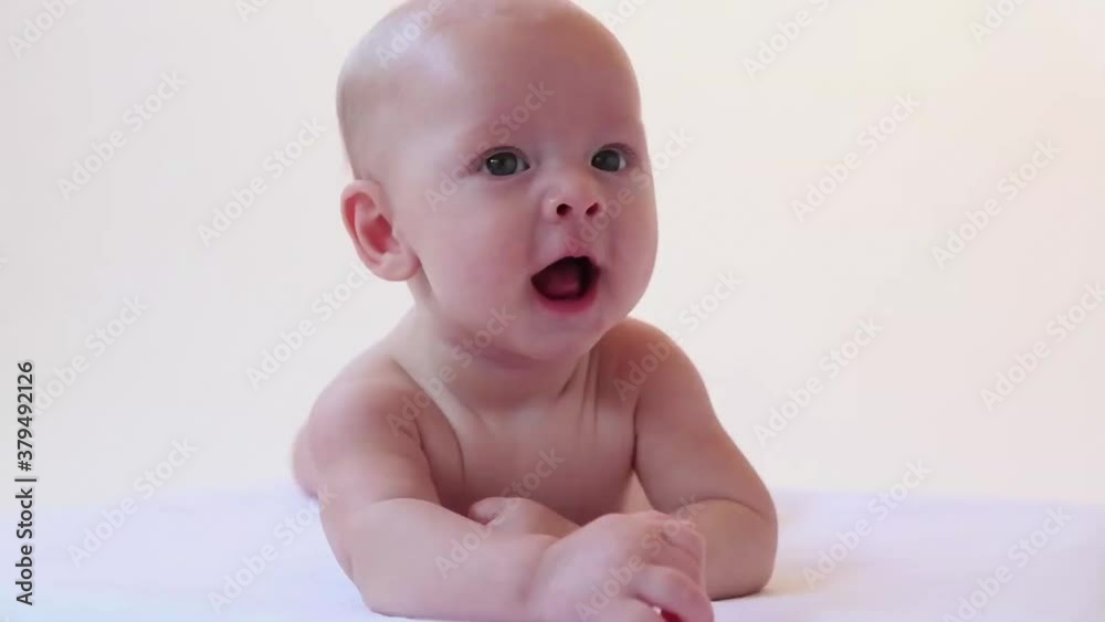 Caucasian baby boy cooing and smiling Caucasian baby boy cooing and smiling