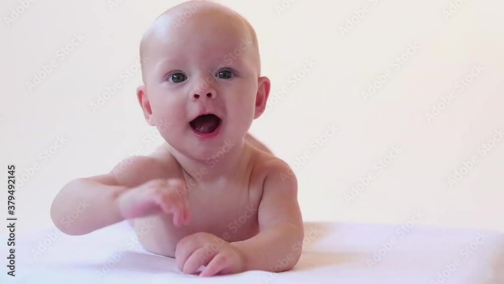 Caucasian baby boy cooing and smiling Caucasian baby boy cooing and smiling