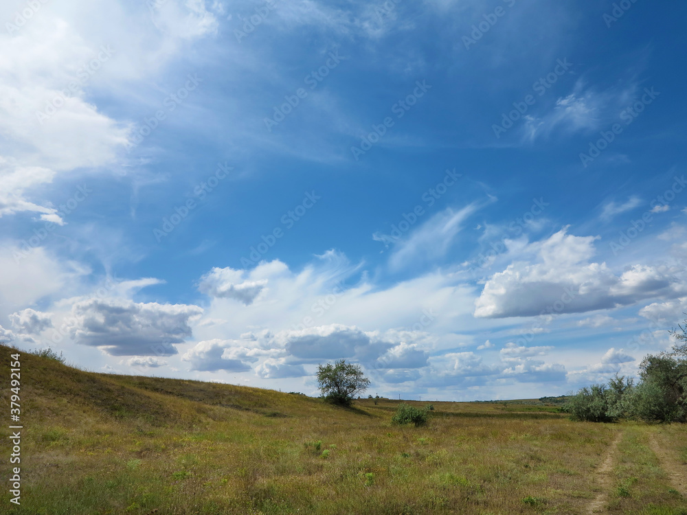 Rural landscape of blue sky in white clouds in the steppe near Odessa, hot summer day Rural landscape of blue sky in white clouds in the steppe near Odessa, hot summer day