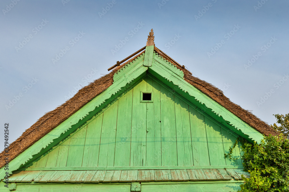 Beautiful wooden decoration on the traditional fronton house in Danube Delta region, using fretwork technique