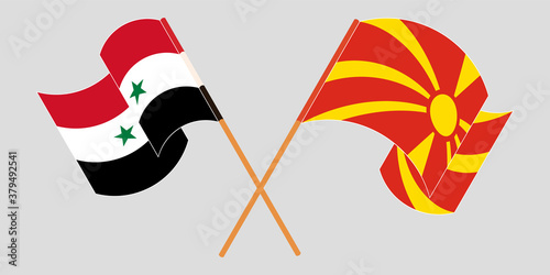 Crossed and waving flags of North Macedonia and Syria