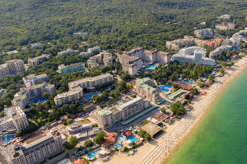 Aerial image a drone resort Golden Sands on Black Sea coast in Bulgaria. Many hotels and beaches with tourists, sunbeds and umbrellas. Sea travel destination. Travel and vacation concept.
