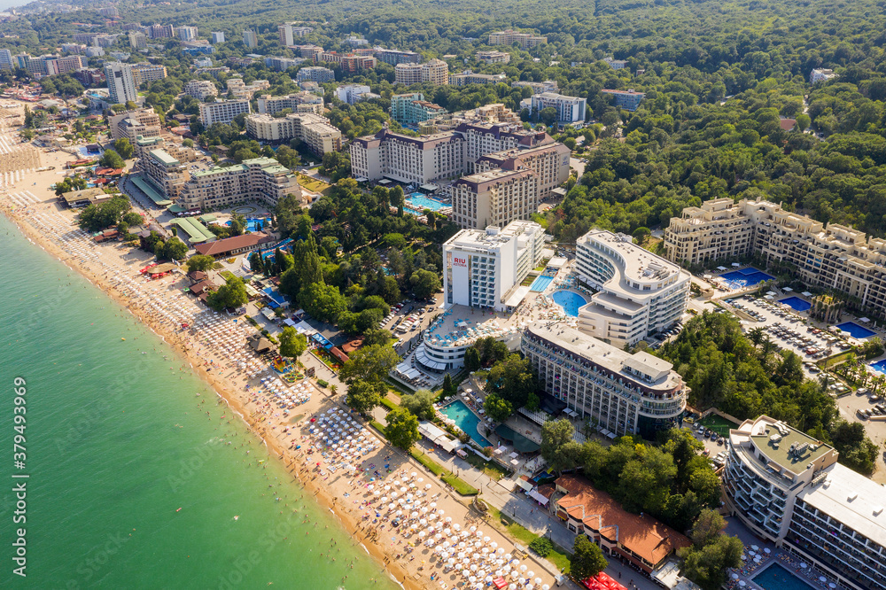Naklejka premium Golden Sands, Bulgaria - July 22, 2019: aerial image a drone. Resort on Black Sea coast. Many hotels and beaches with tourists, sunbeds and umbrellas. Travel and vacation concept.