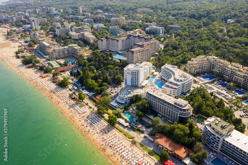 Golden Sands, Bulgaria - July 22, 2019: aerial image a drone. Resort on Black Sea coast. Many hotels and beaches with tourists, sunbeds and umbrellas. Travel and vacation concept. © Elena